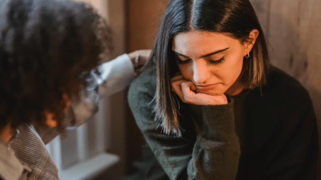 A woman comforting her upset friends