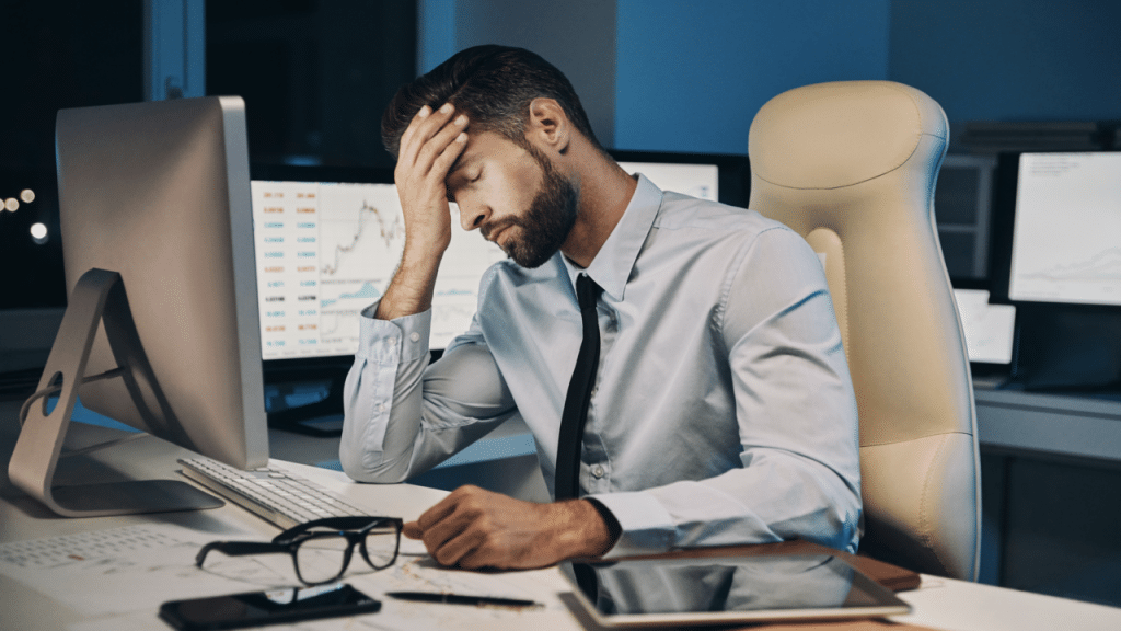 A man looking stressed at work