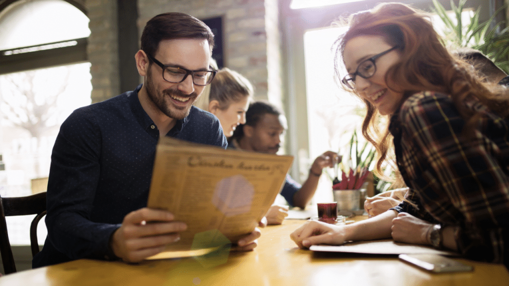 Colleagues smiling while looking at the menu