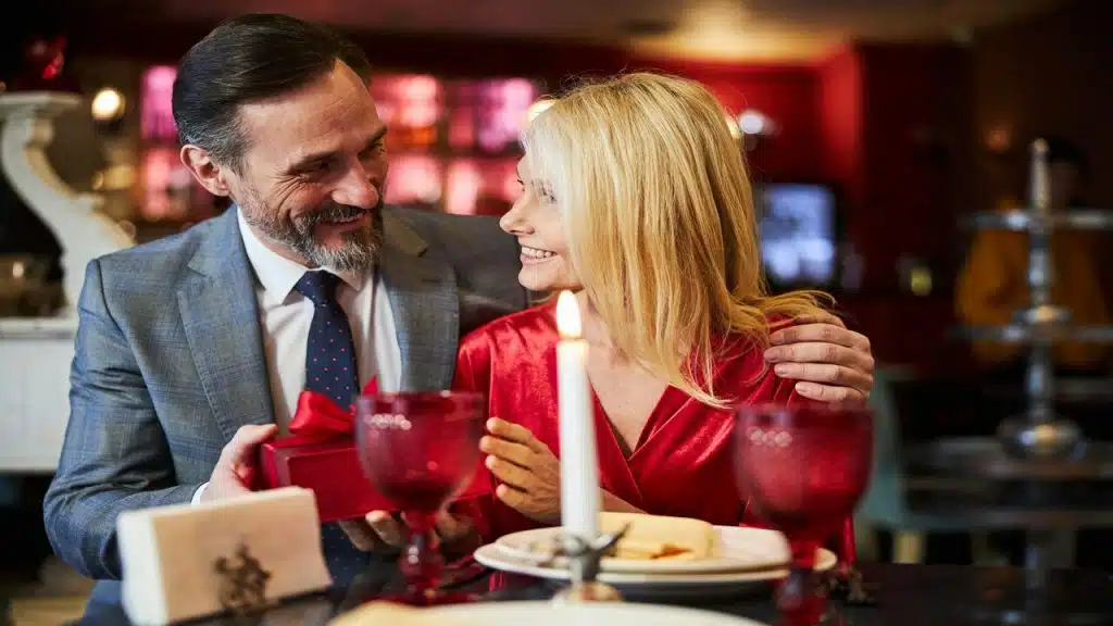 A man giving his date a gift