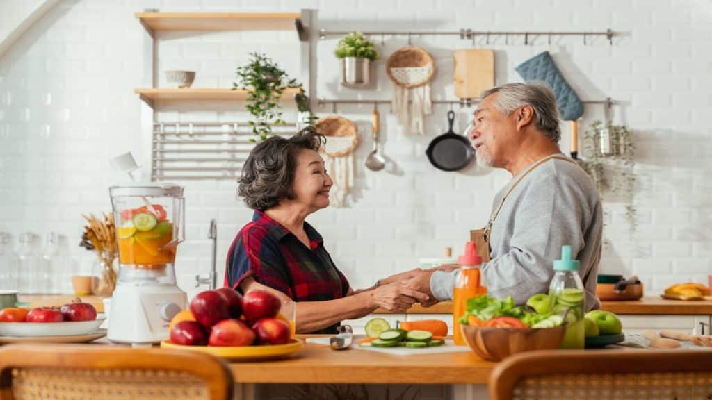 A couple holding hands in the kitchen