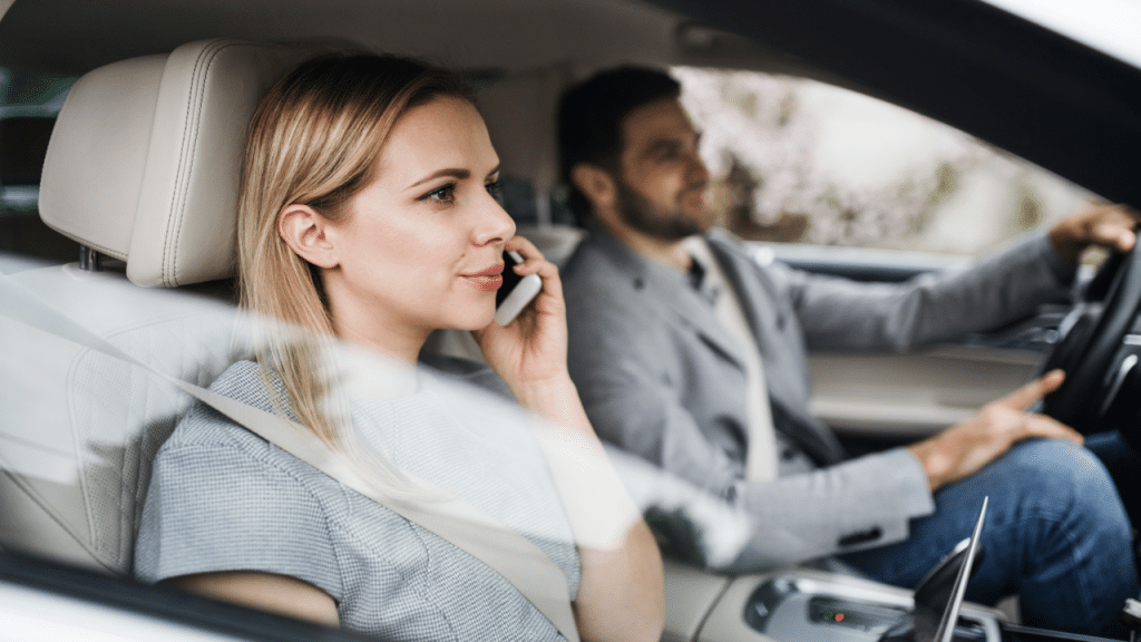 A couple driving to work together