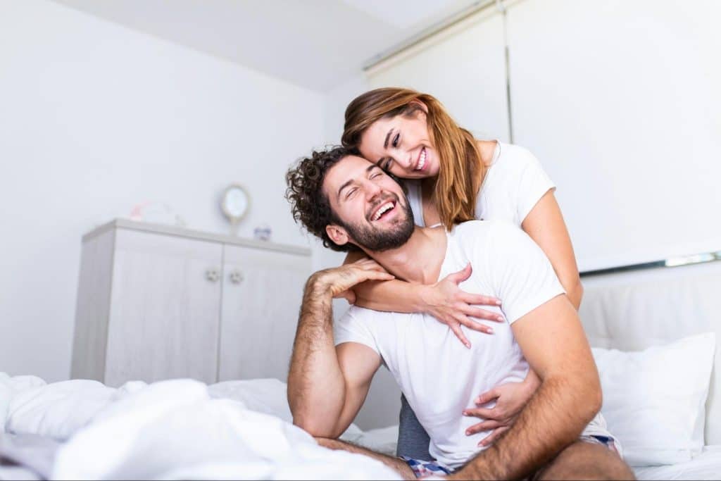 A woman hugging a man