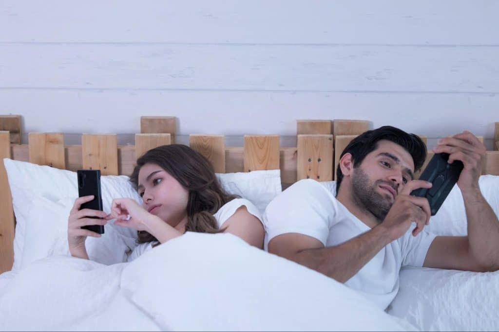 A man and woman busy with their phones