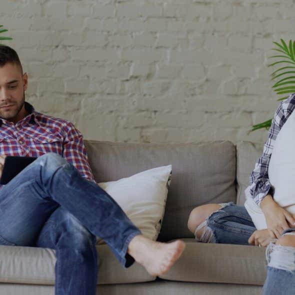 A couple ignoring each other at home