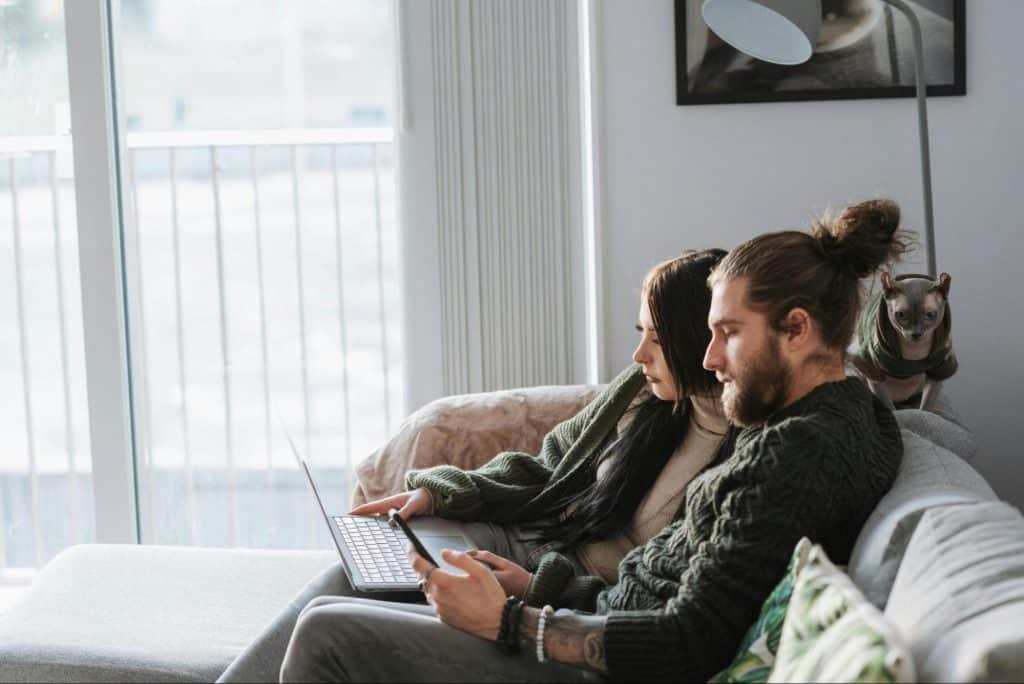 A man and woman resting at the sofa