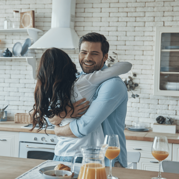 A couple hugging in the kitchen