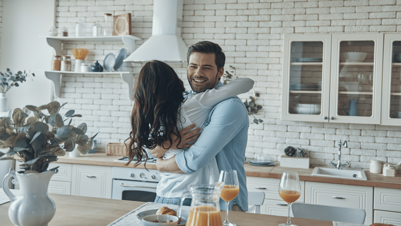 A couple hugging in the kitchen