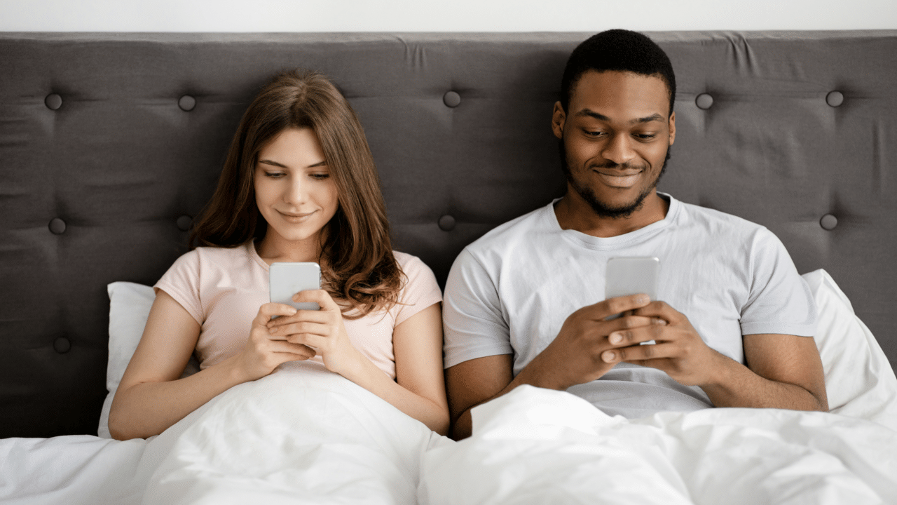 A couple busy with their own phones