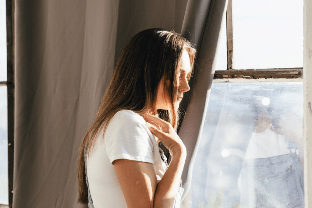 Girl in White Shirt Near a Glass Window