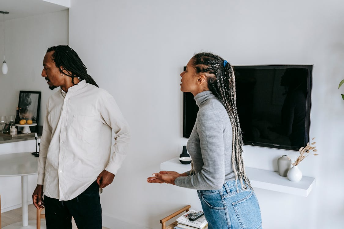 Expressive african american couple quarreling in room