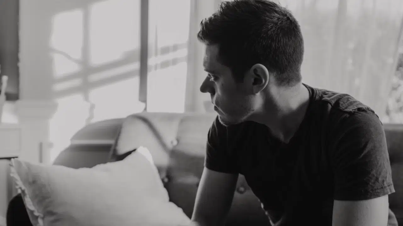 A man deep in thought at home
