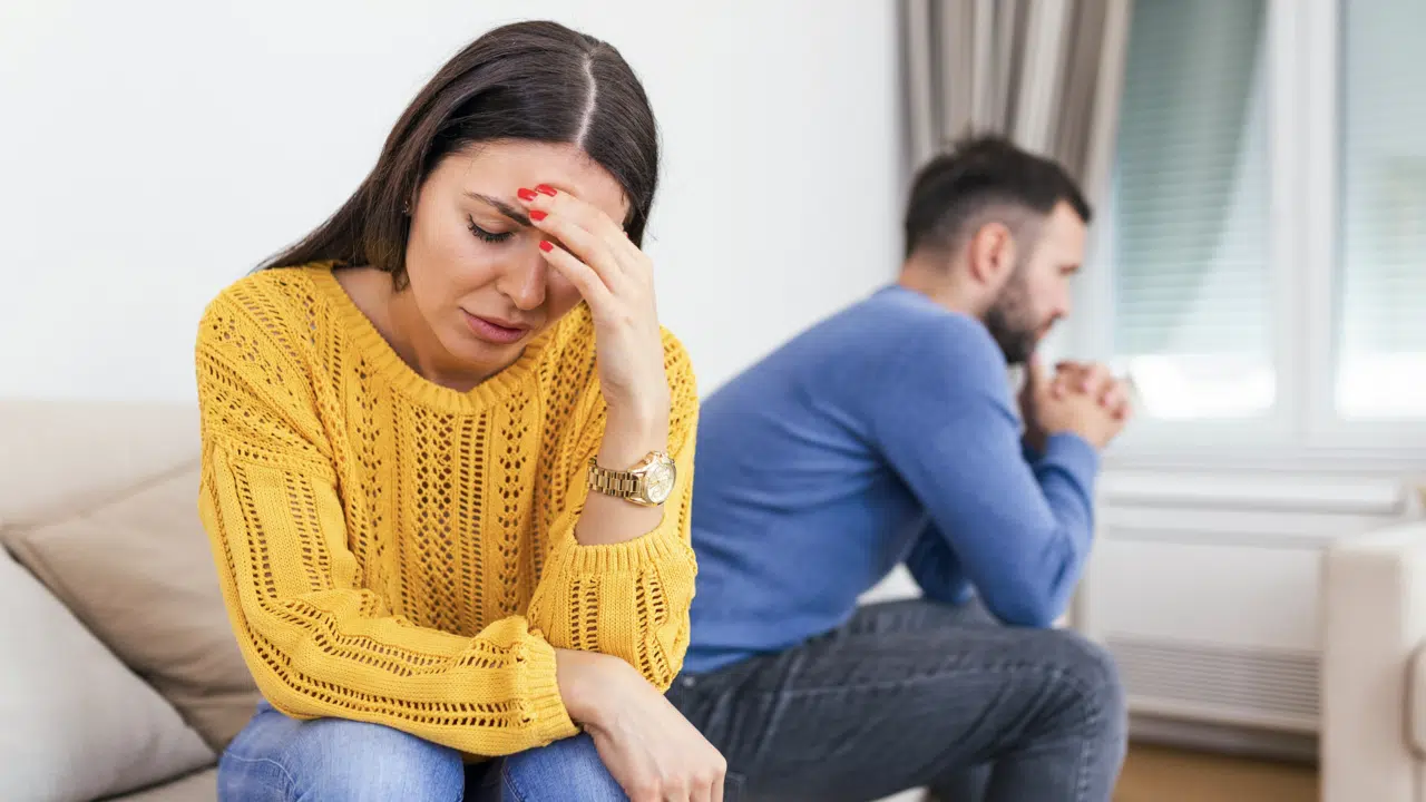 A woman looking upset at her husband