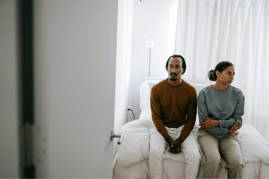 Black couple spending time on bed at home