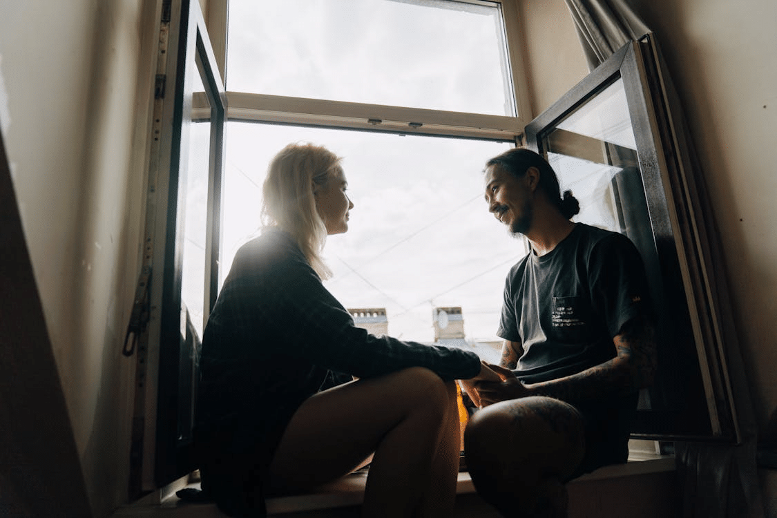 A couple sitting by the window