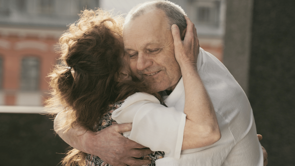 A couple hugging outdoors