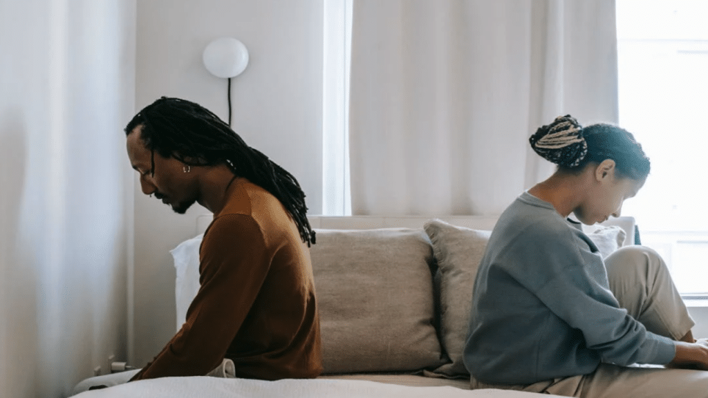 A couple ignoring each other in the bedroom