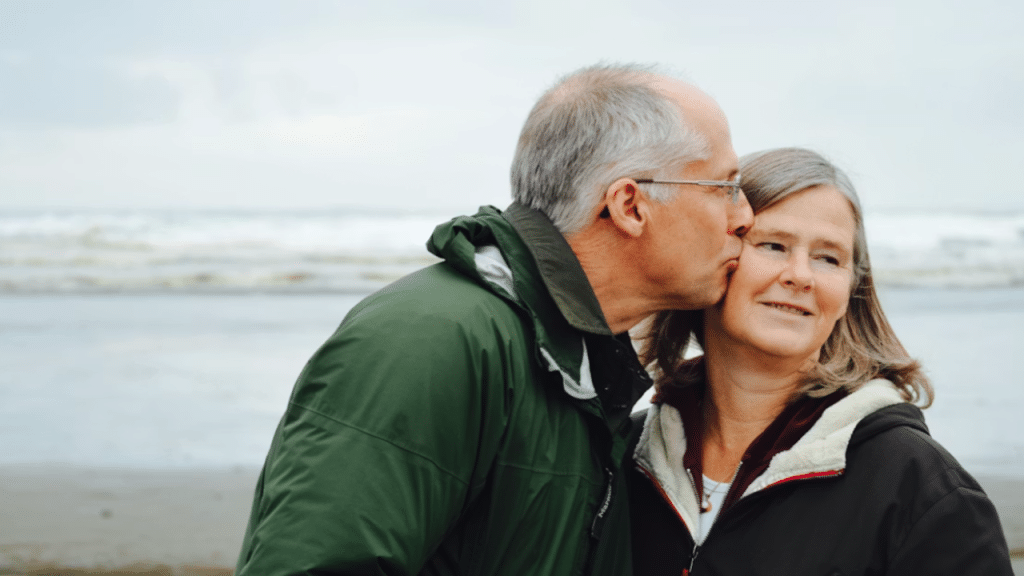 A husband kissing his wife on the cheek