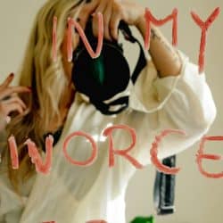 A woman takes a mirror selfie with the text "divorced era."