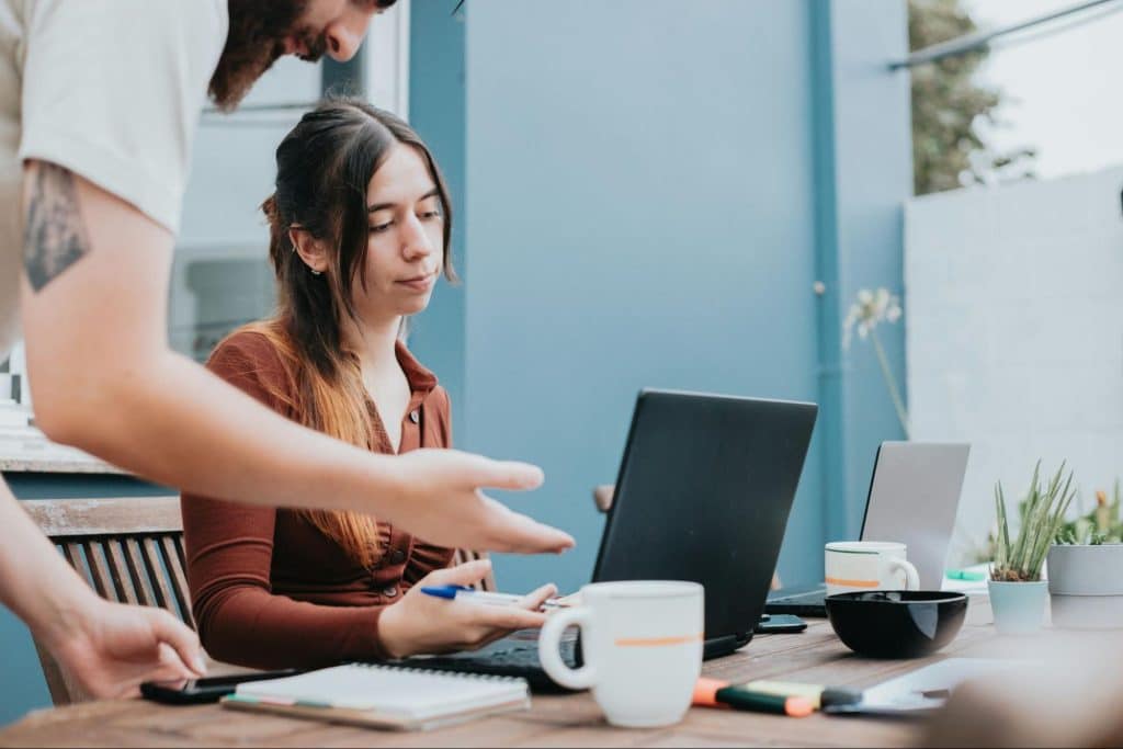 A  man saying something to a woman