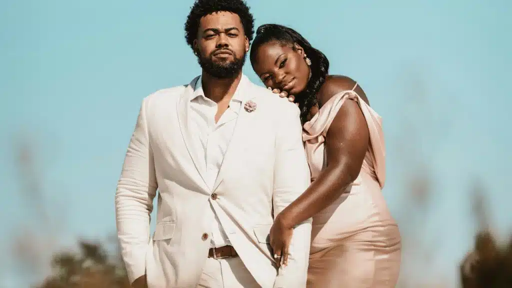A man and a woman standing in the field.