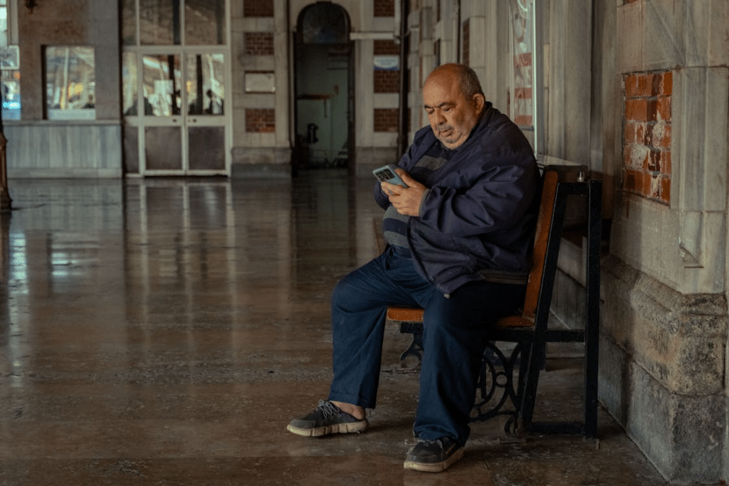 Man Sitting on a Train Station