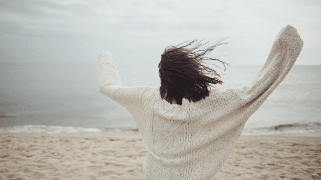 A woman celebrating at the beach
