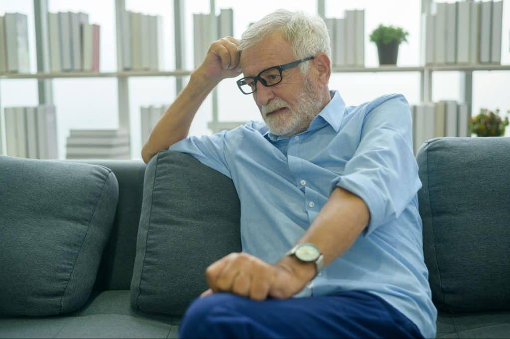 A man alone sitting at the couch