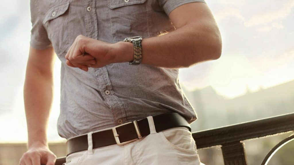 A person checking the time on a wristwatch.