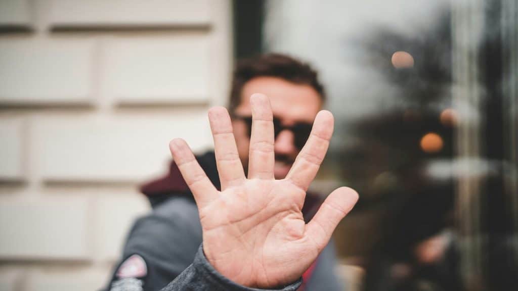 A man saying “no” with his hand