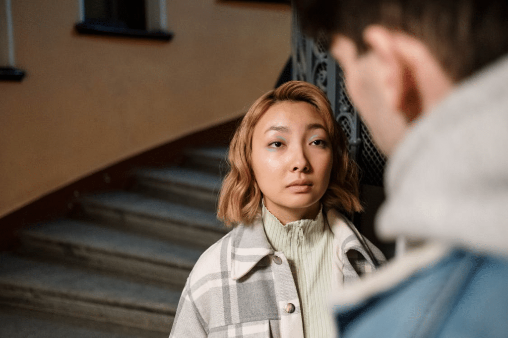 Woman talking to a man near the stairs