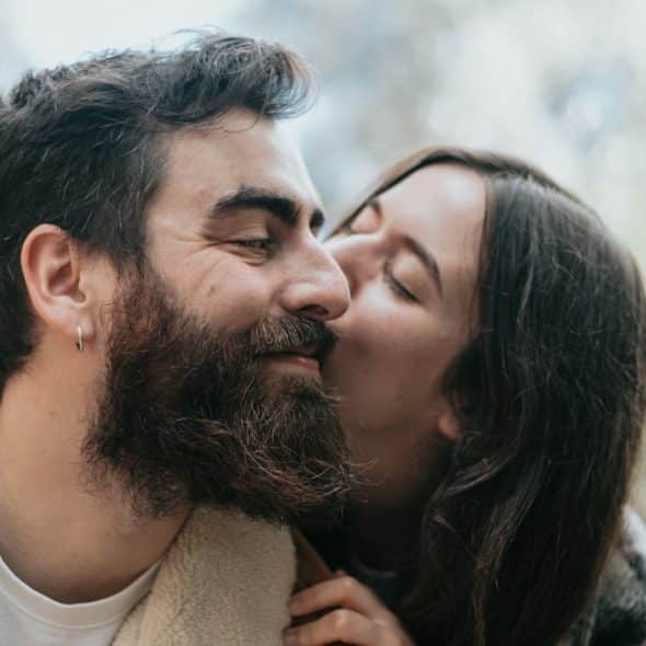 A man and a woman kissing each other outdoors