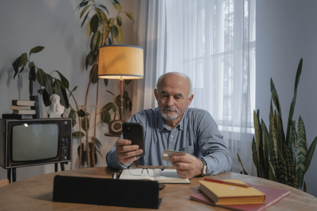 Man Holding Smartphone and a Credit Card