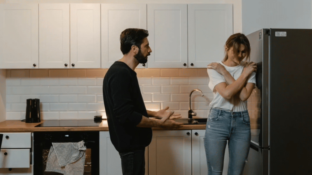 A man yelling at his wife in the kitchen