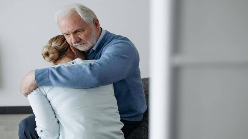 A man consoling his upset wife