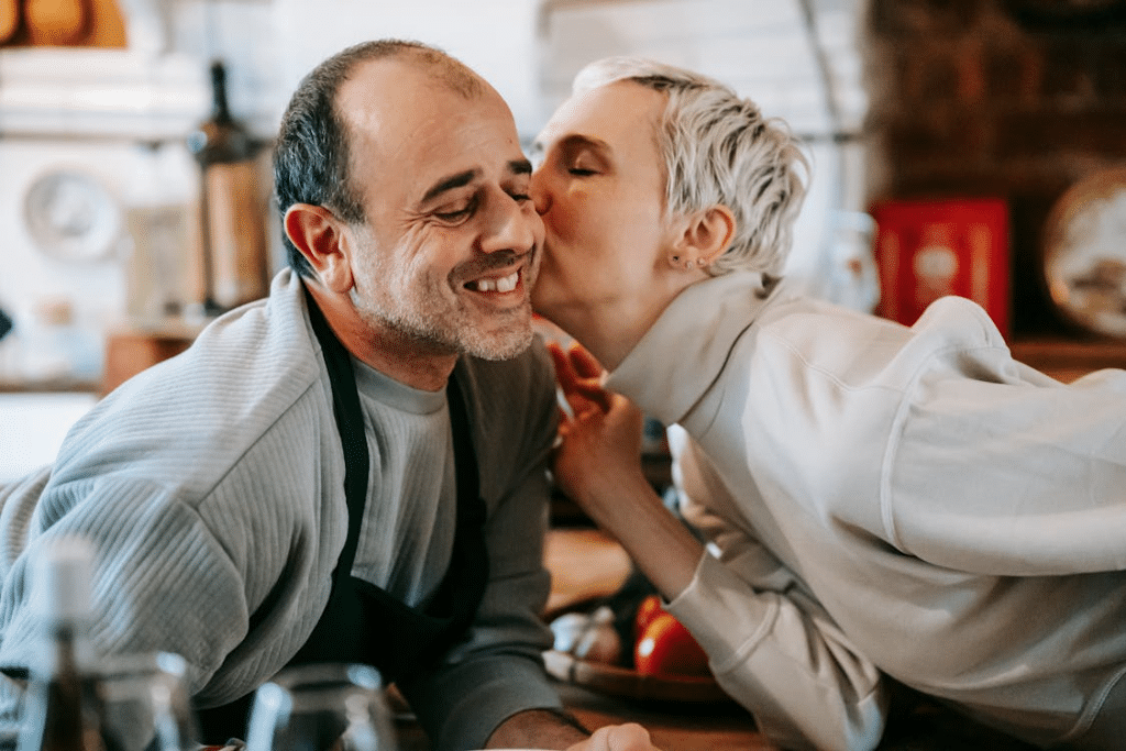 A woman kissing a man on the cheek