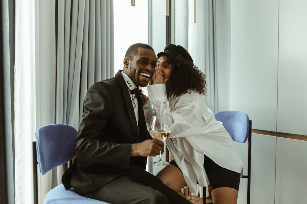 A woman whispering to a man