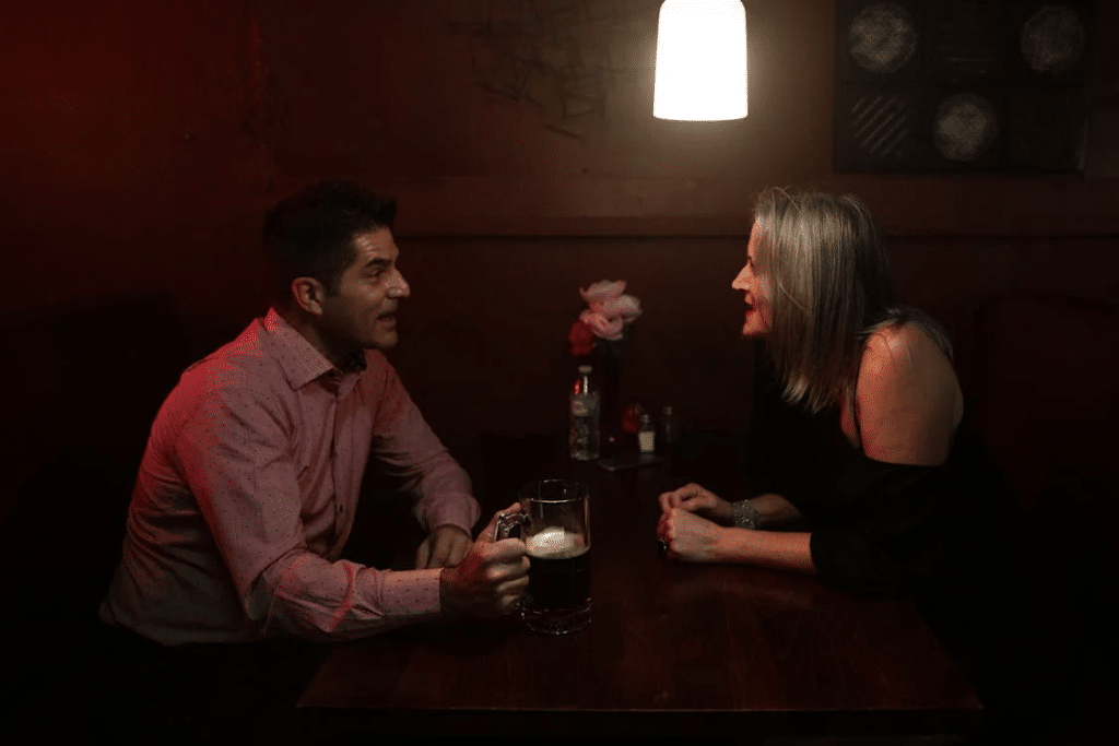 A man and woman sitting at the table talking