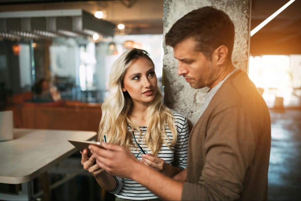 A man checking something on woman’s work