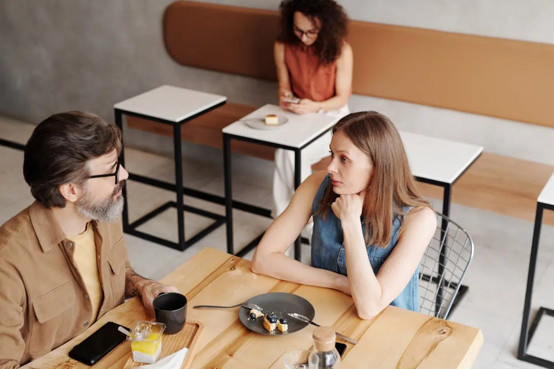 A man and woman sitting at the table