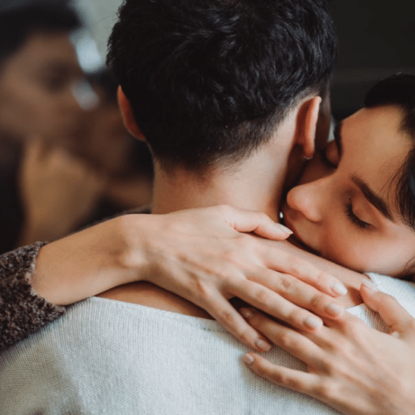 A couple hugging at home