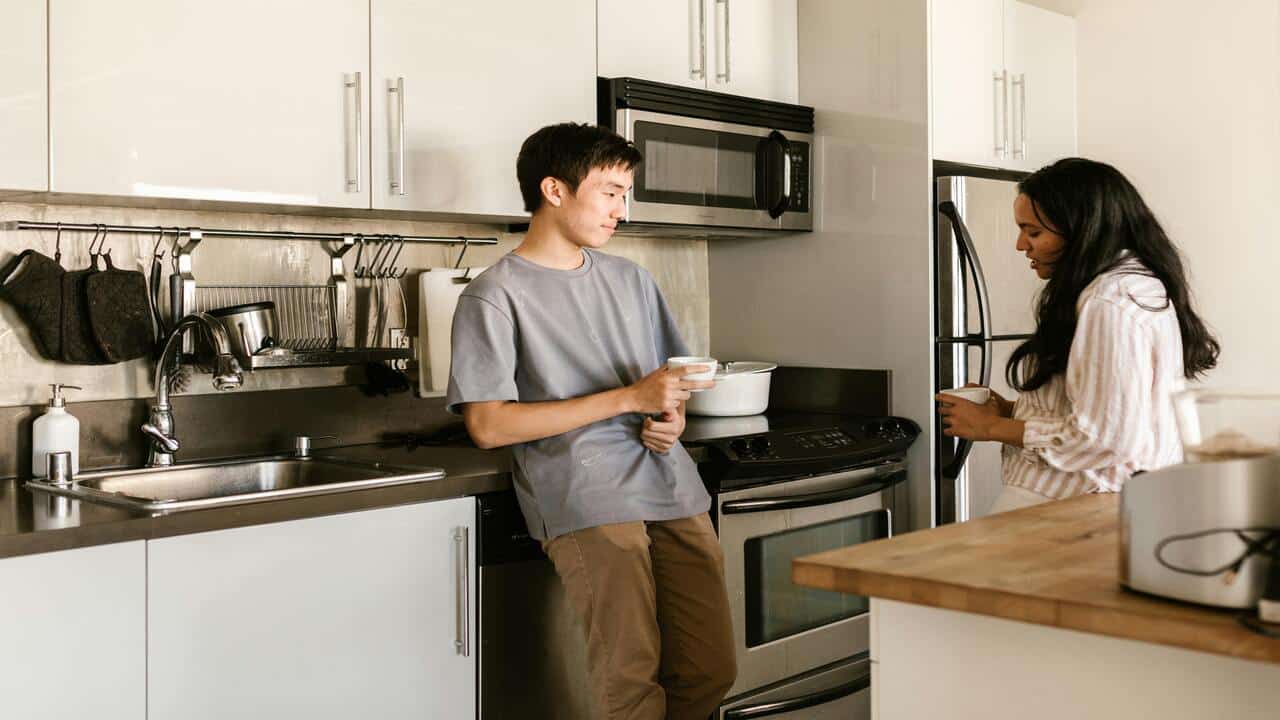 A couple talking in the kitchen