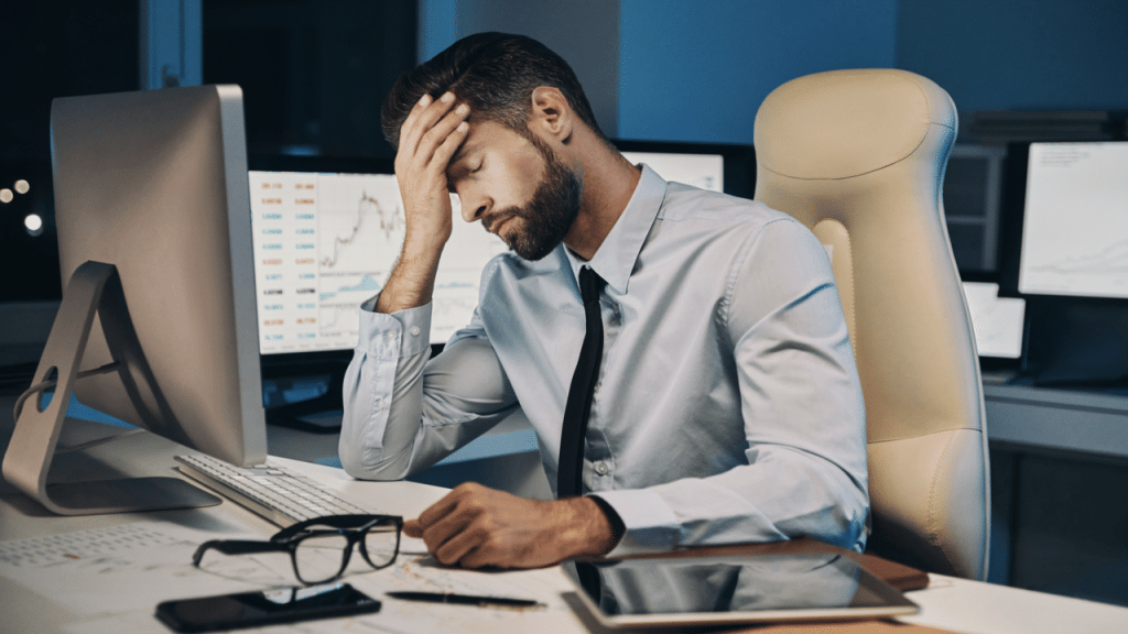 A man looking stressed at work