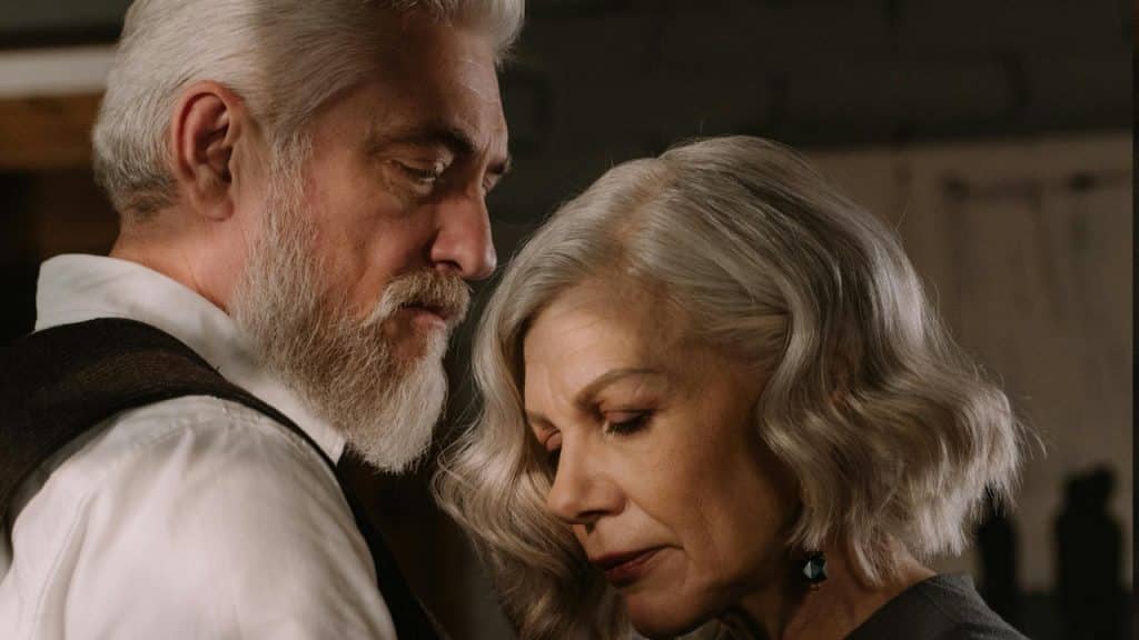 A man looking at a woman while she looks away.