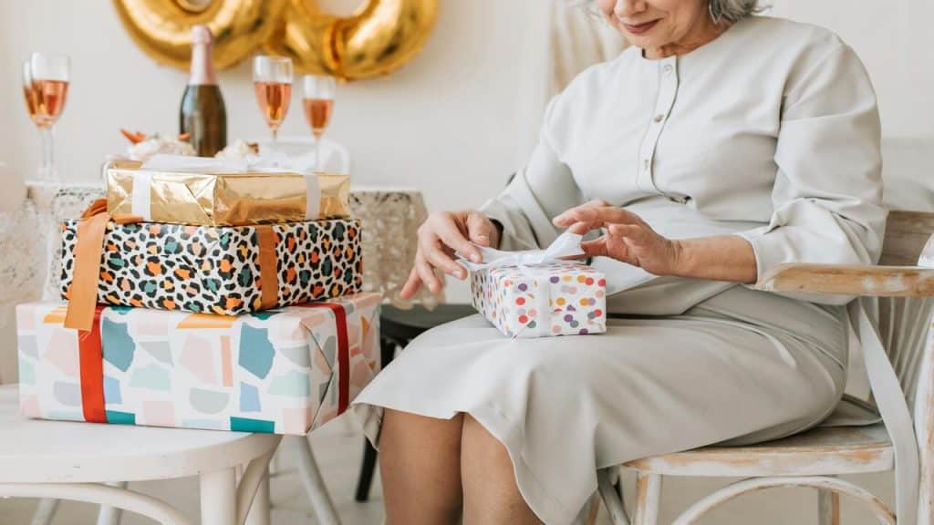 A woman opening her birthday gift