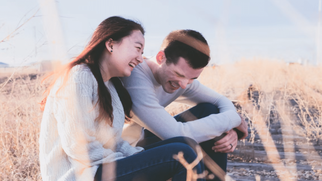 A couple laughing outdoors