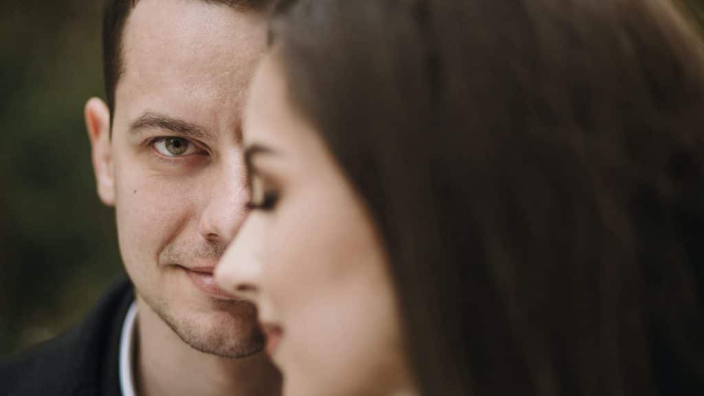 A closeup of a man  and a woman, The man is looking in the camera.