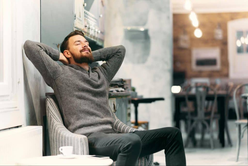 A man relaxing alone at the sofa