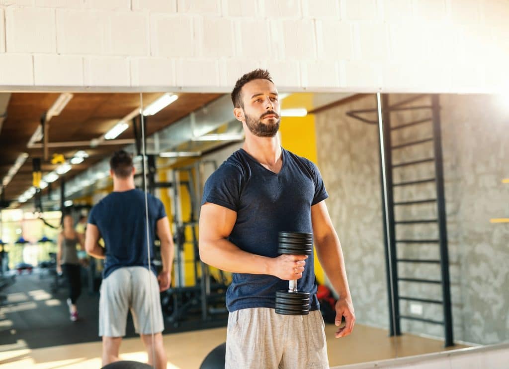 A man holding a dumbbell.