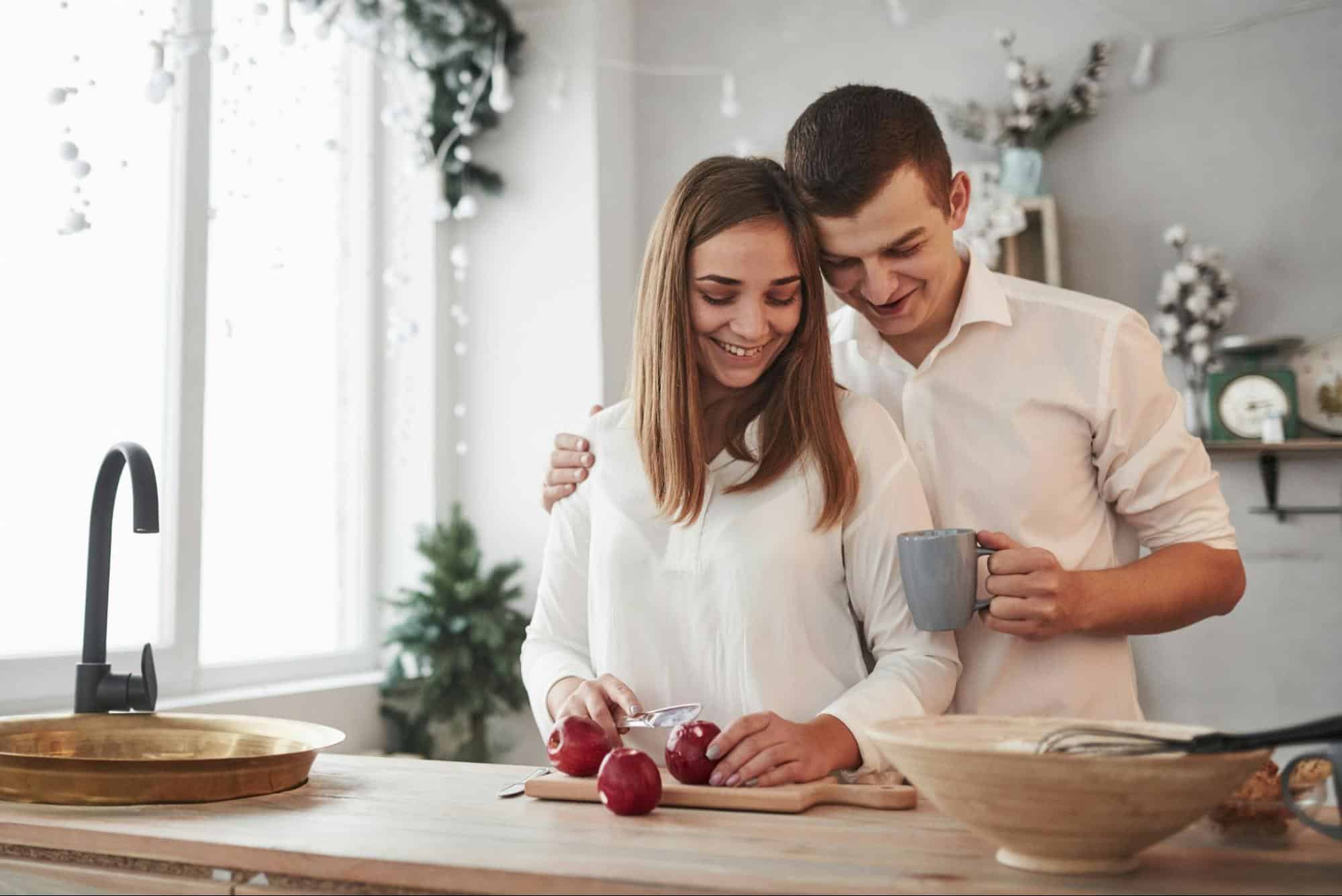 A man and woman preparing food together 